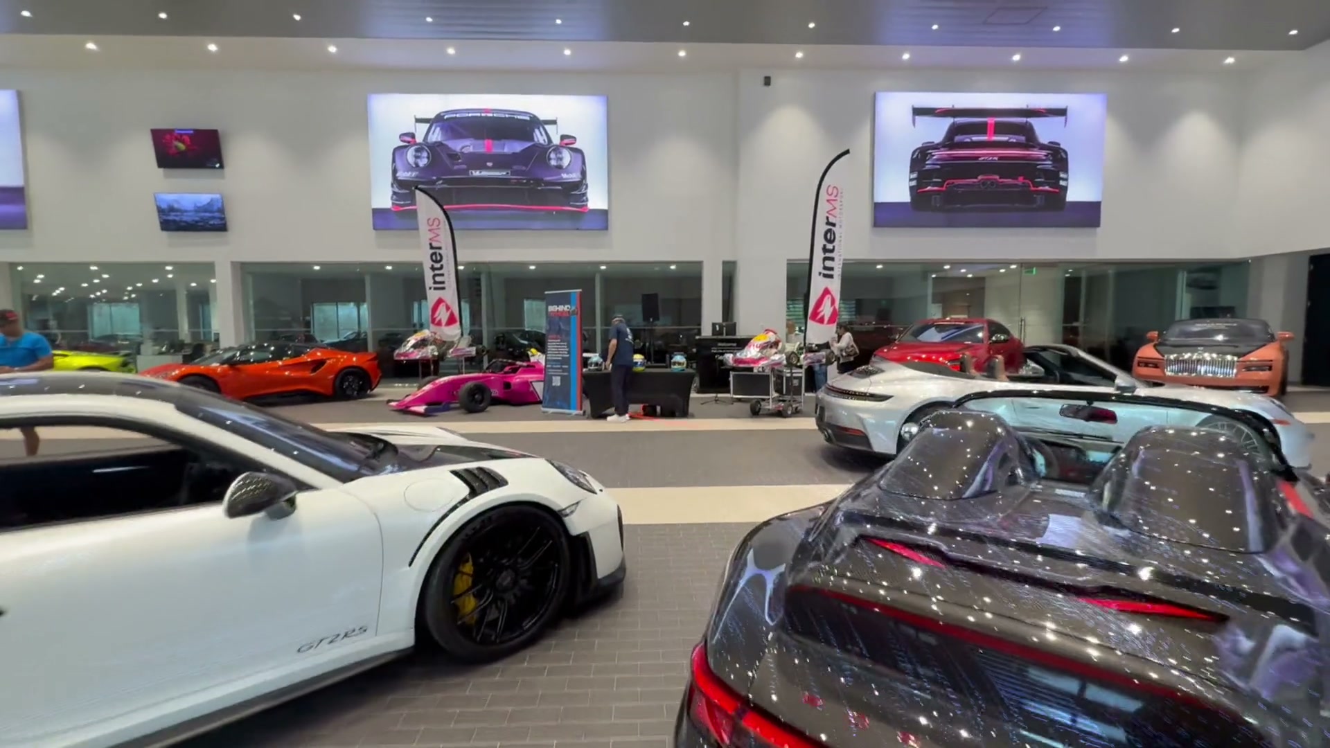 Porsche North Miami showroom floor during the Miami DJ Beat corporate activation, sports cars on display